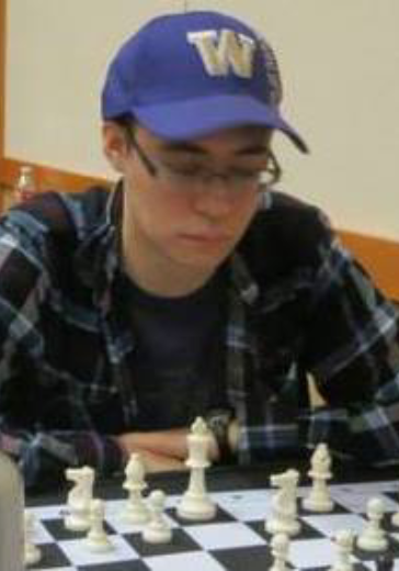 a boy concentrating on his chess game